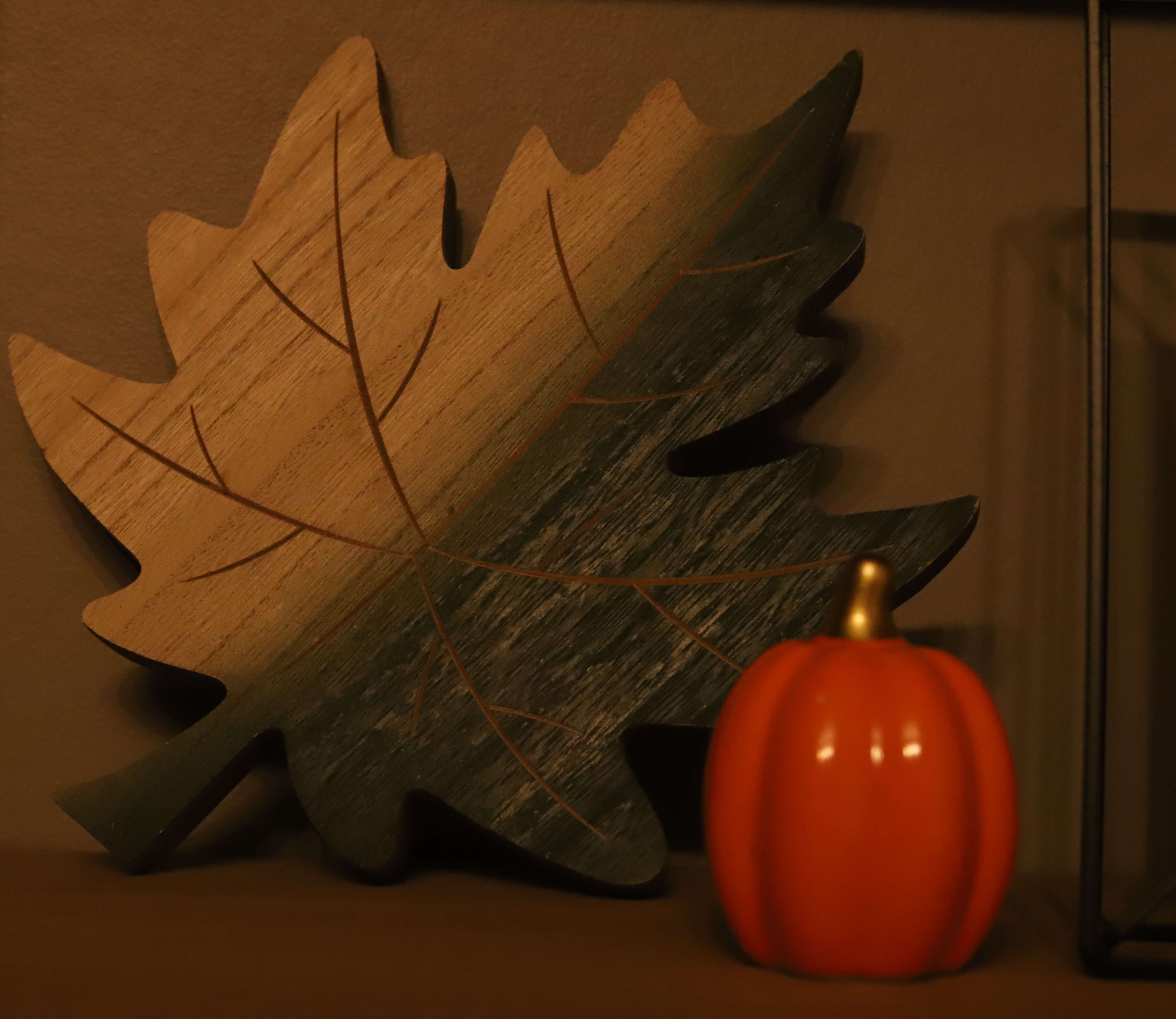 Decorative pumpkin and wooden leaf